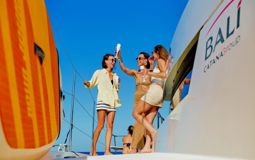 Guests enjoying drinks on a catamaran during a cruise from Ierapetra to Chrissi Island.