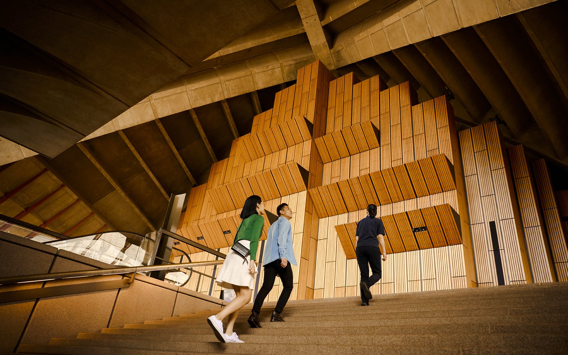 Visitors ascending steps inside Sydney Opera House on a guided tour.