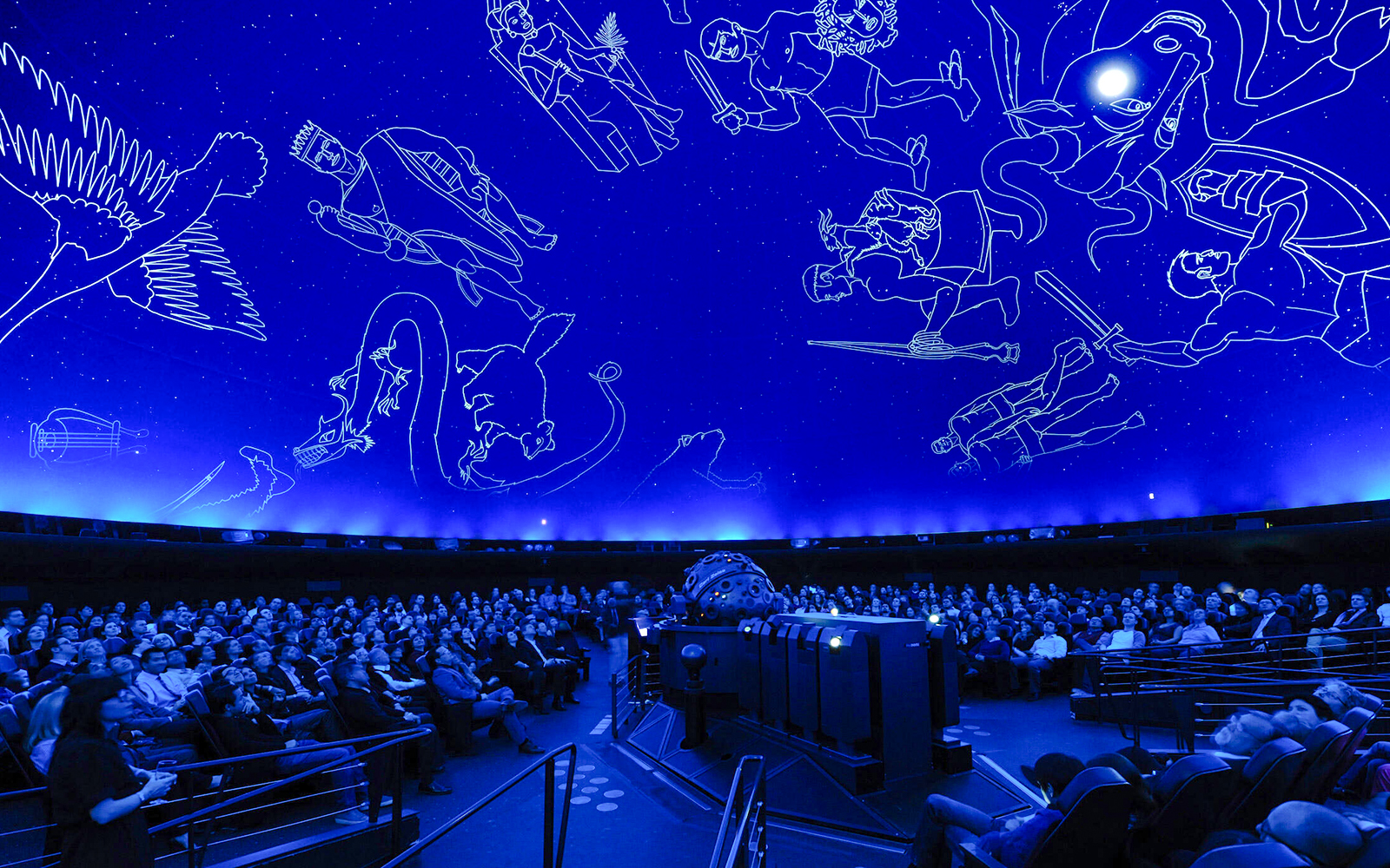 Visitors seated under starry dome at Hayden Planetarium, American Museum of Natural History.