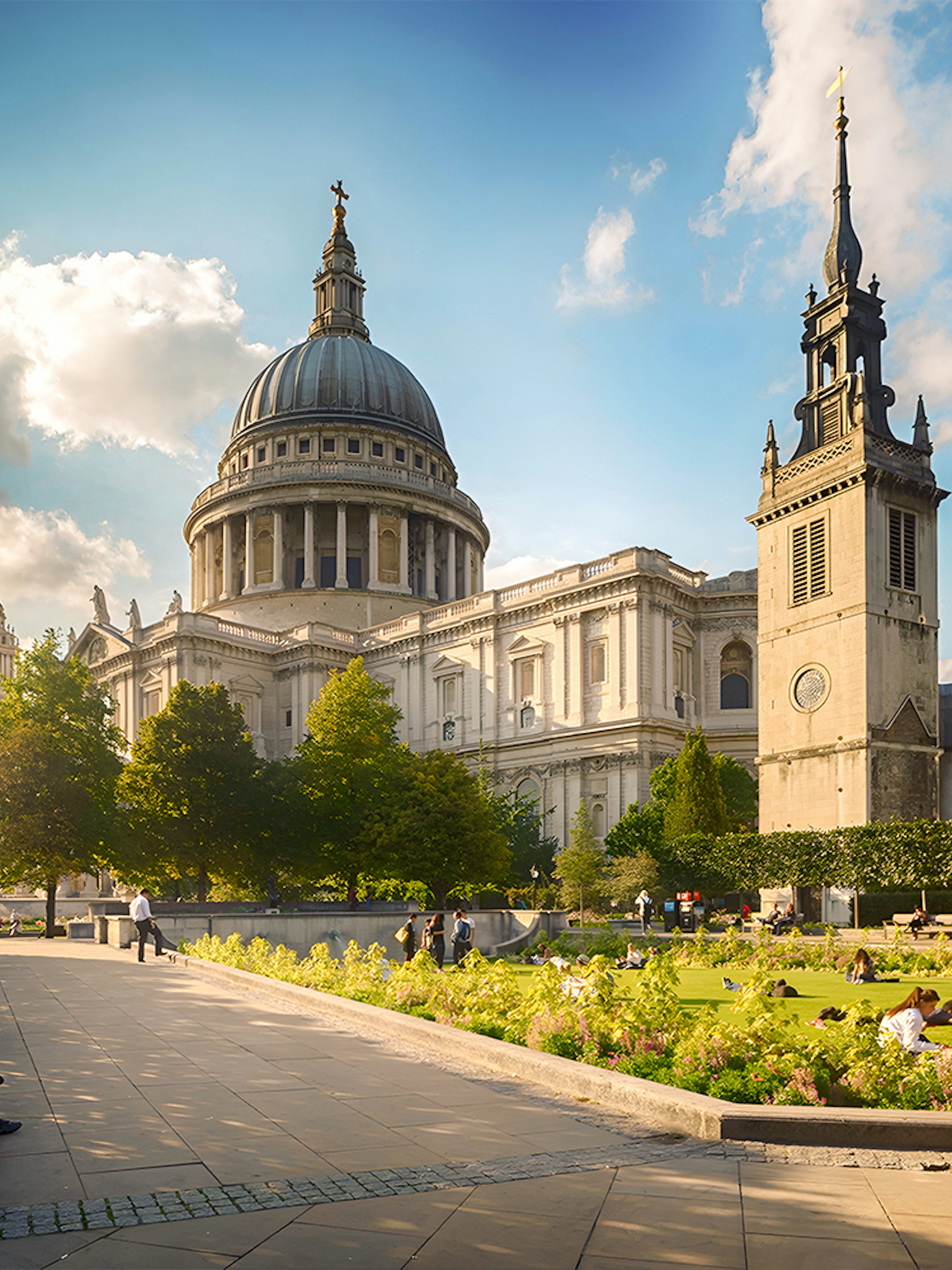 St. Paul's Cathedral in London with people relaxing in the garden.
