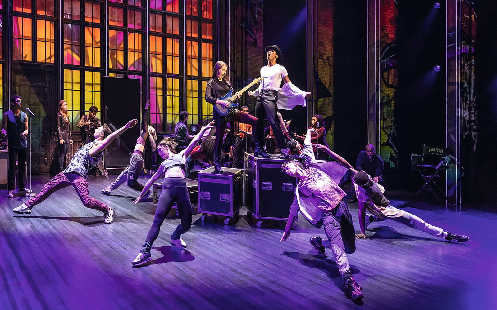 Performers dancing energetically on stage during MJ Das Musical.