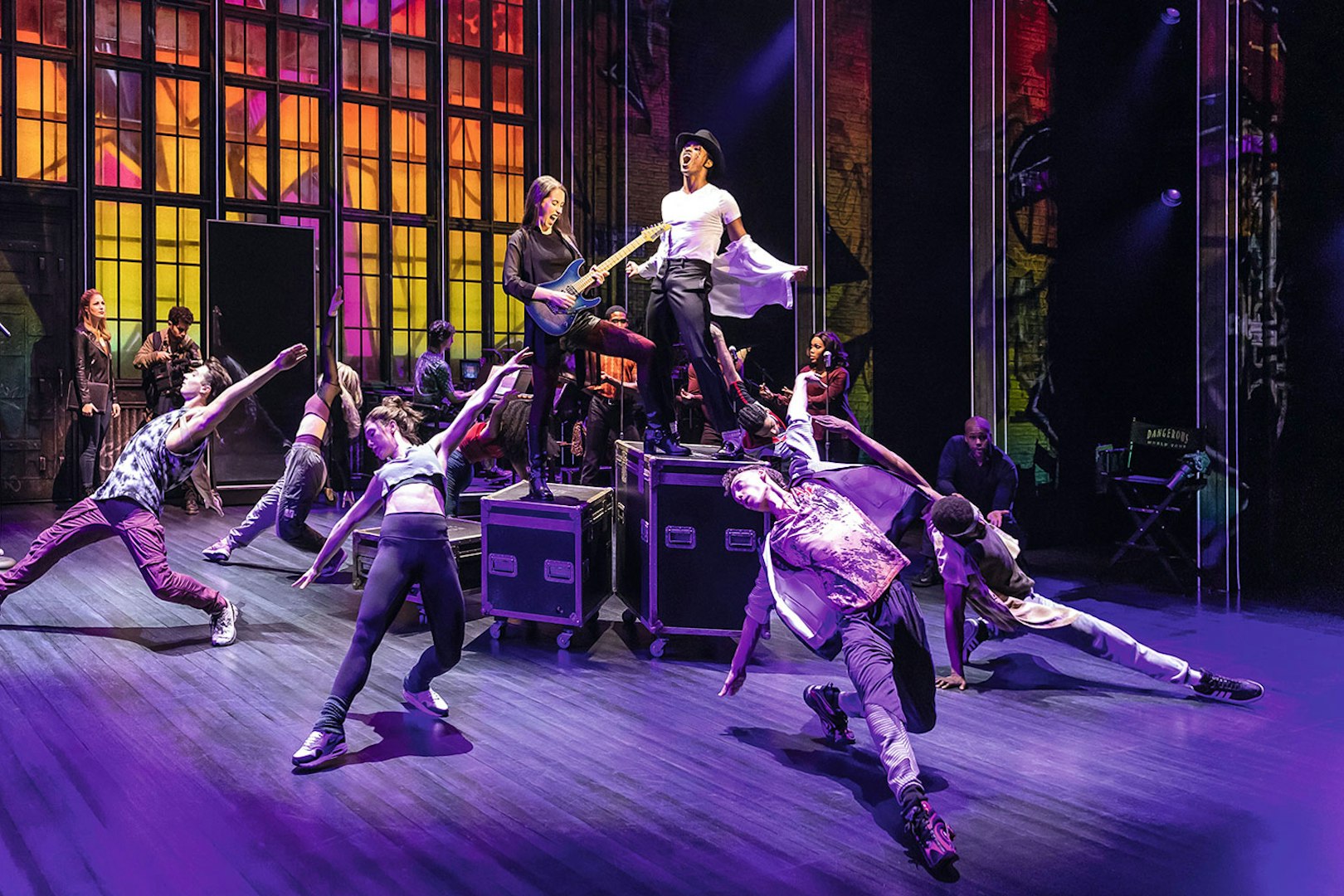 Performers dancing energetically on stage during MJ Das Musical.