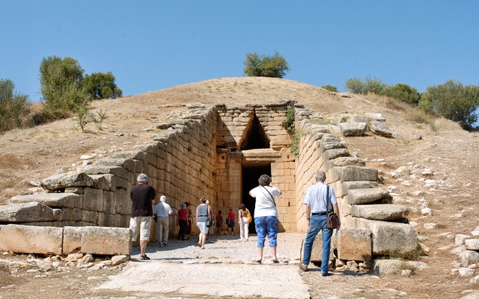 Visitors entering the Tomb of Agamemnon in Mycenae, Greece.