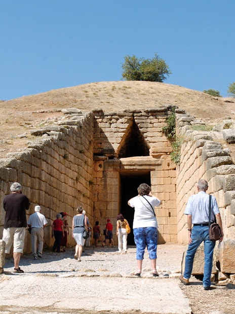 Visitors entering the Tomb of Agamemnon in Mycenae, Greece.
