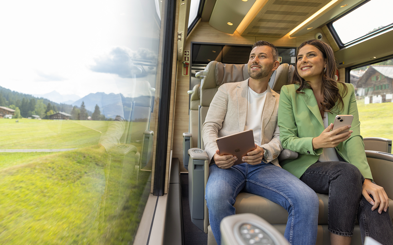 A couple enjoying panoramic view in the Prestige Class of Glacier Express