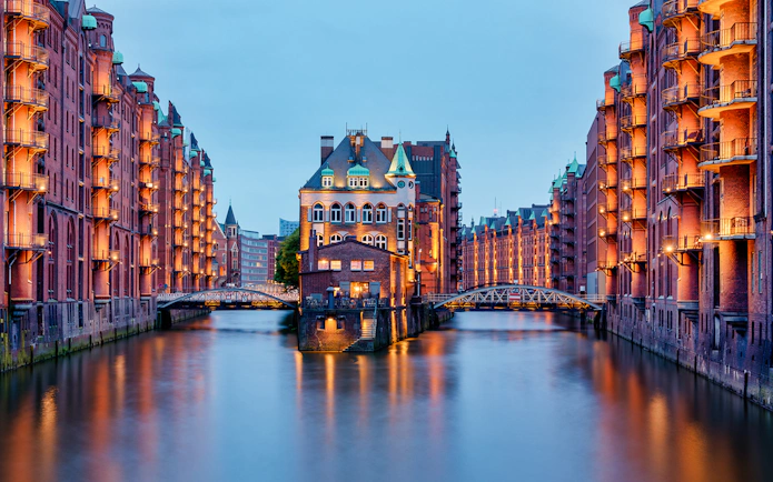 Historic Speicherstadt warehouses in Hamburg at dusk, part of HafenCity 3-hour food tour.