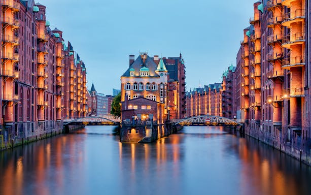 Historic Speicherstadt warehouses in Hamburg at dusk, part of HafenCity 3-hour food tour.
