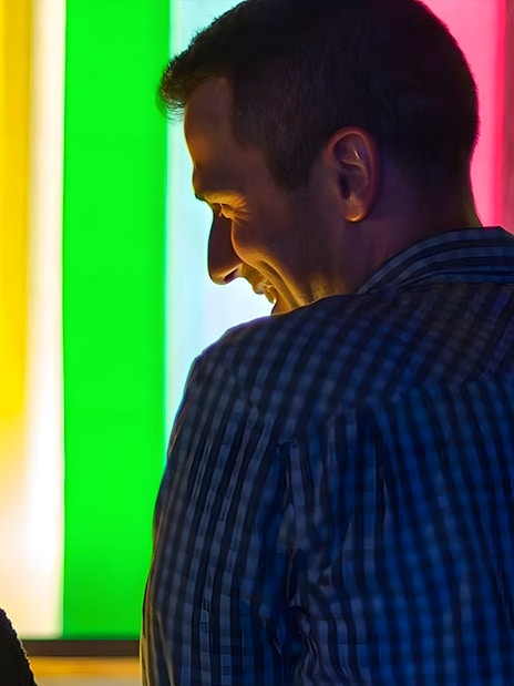 Visitors enjoying colorful light exhibit at the Exploratorium, San Francisco.