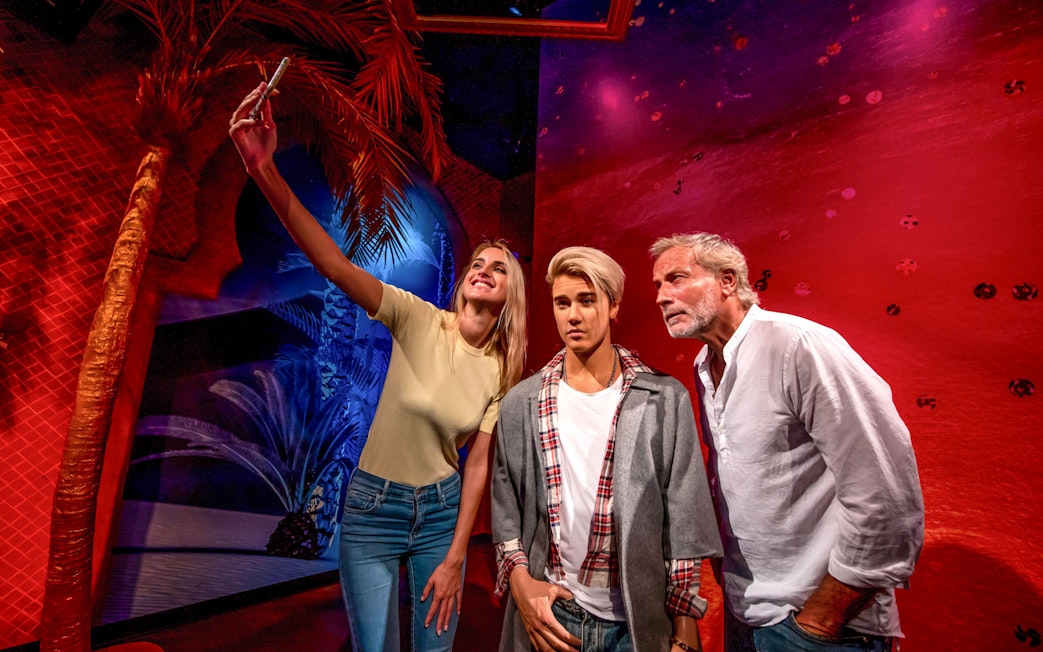 Fans taking a selfie with Justin Bieber wax statue at Madame Tussauds Dubai.