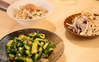 Cucumber salad and root vegetable dishes prepared in a Tokyo izakaya-style cooking class.