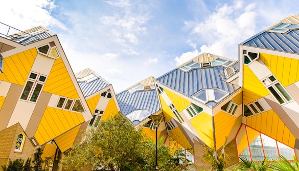Rotterdam Cube Houses with yellow and white geometric design under blue sky.