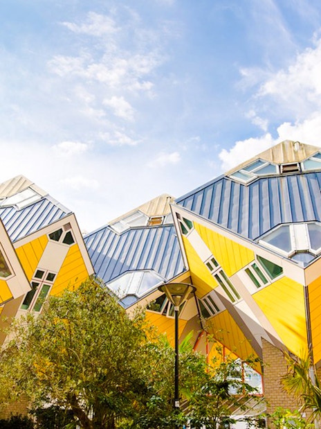 Rotterdam Cube Houses with yellow and white geometric design under blue sky.