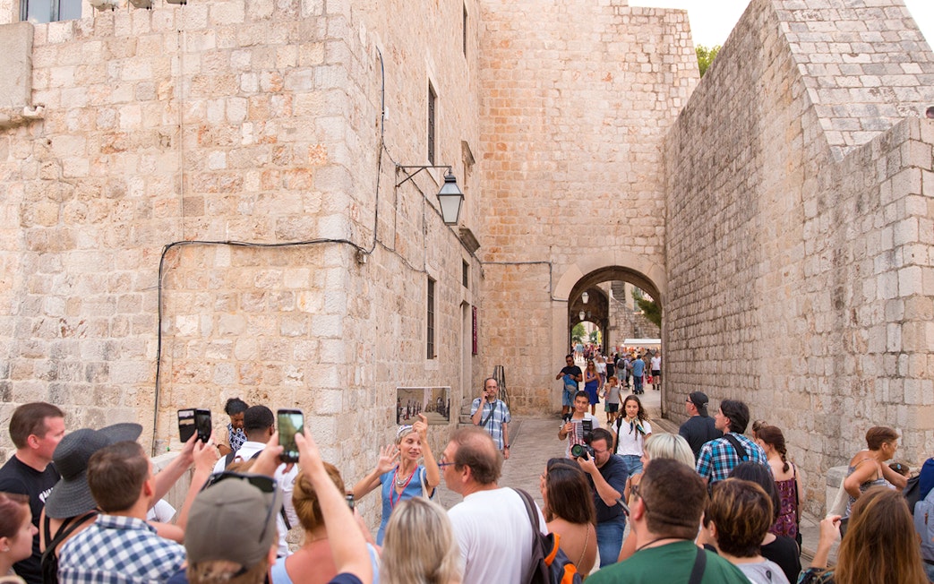 Tour group exploring Dubrovnik's historic walls on a Game of Thrones walking tour.