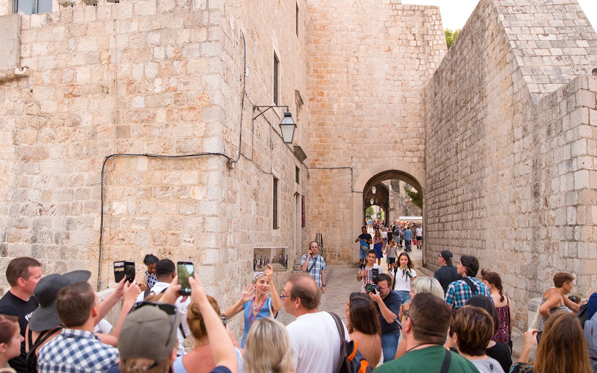 Tour group exploring Dubrovnik's historic walls on a Game of Thrones walking tour.