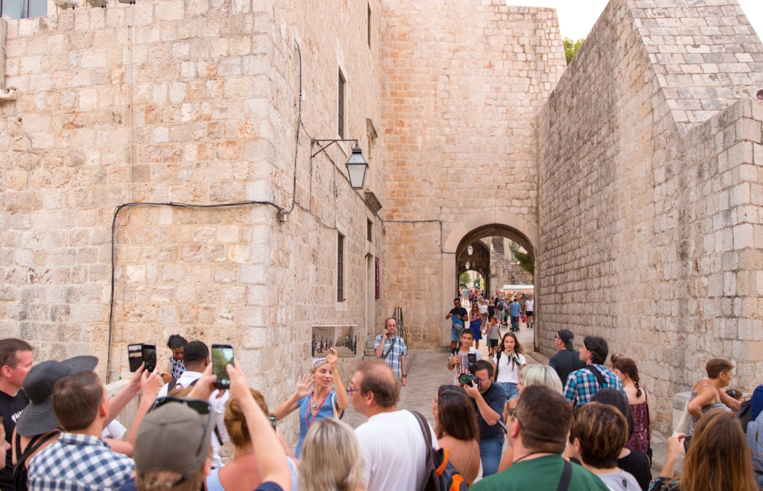 Tour group exploring Dubrovnik's historic walls on a Game of Thrones walking tour.