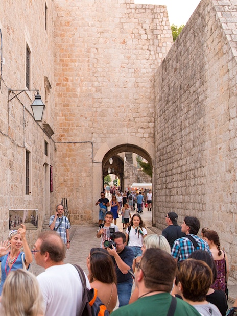 Tour group exploring Dubrovnik's historic walls on a Game of Thrones walking tour.