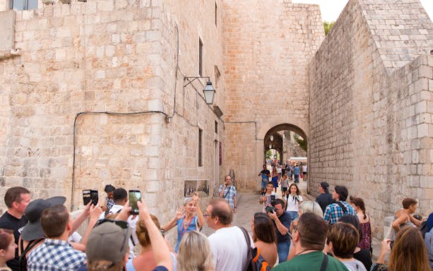 Tour group exploring Dubrovnik's historic walls on a Game of Thrones walking tour.