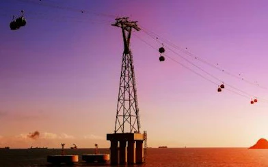 Cable cars over water at sunset in Dubai, part of Big 3 Pass tour.