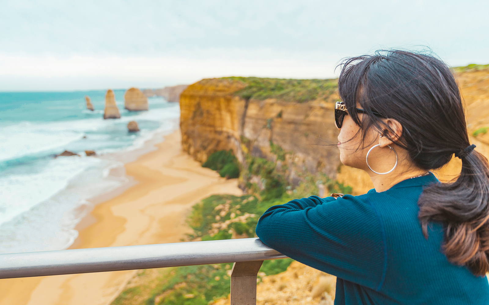 Woman at viewpoint overlooking 12 Apostles along Great Ocean Road, Melbourne