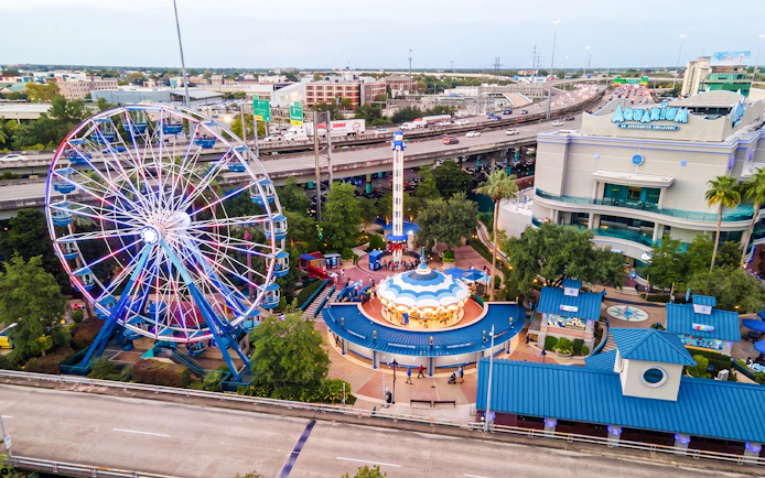 Ferris wheel and carousel at Downtown Aquarium Houston with nearby highway.
