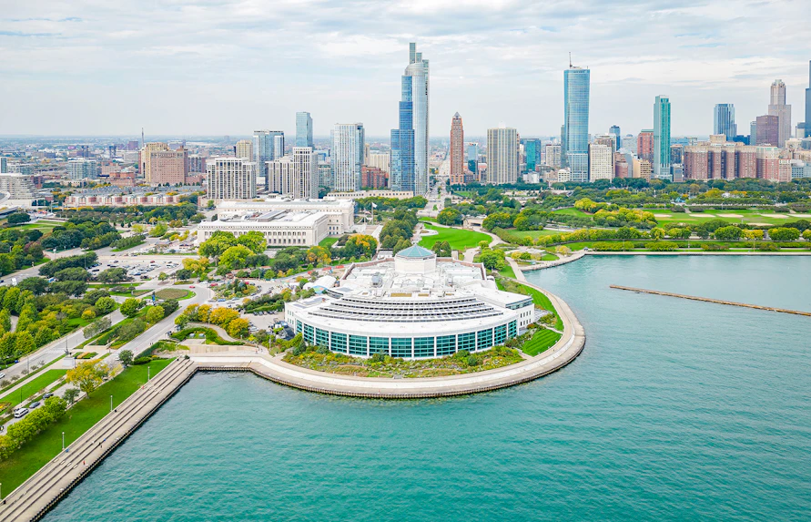 Shedd Aquarium by Lake Michigan with Chicago skyline in the background.