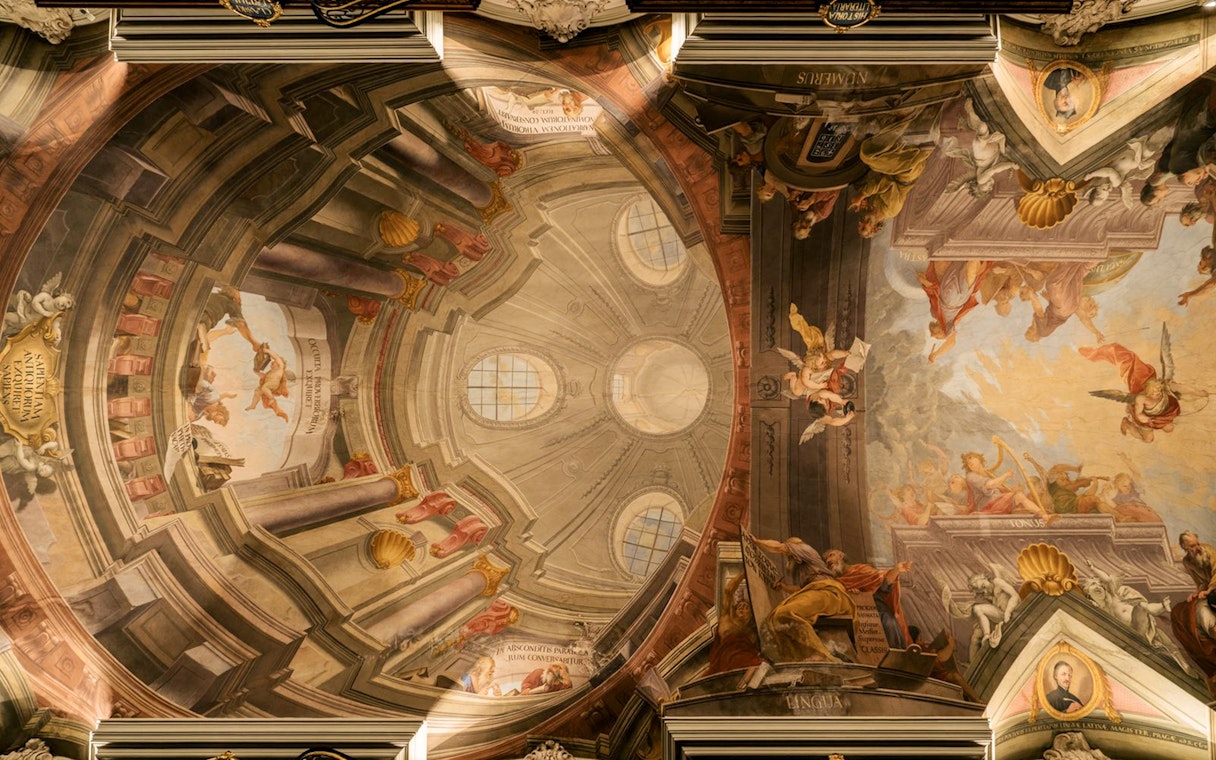 Ceiling fresco depicting angels and classical figures in the Baroque Library.