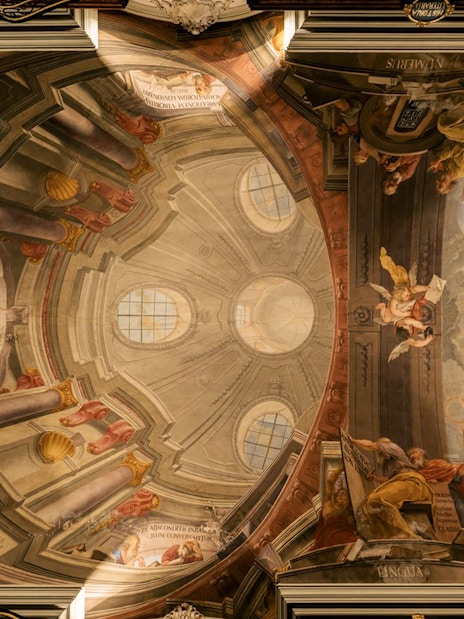 Ceiling fresco depicting angels and classical figures in the Baroque Library.