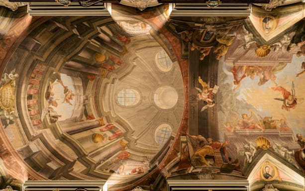 Ceiling fresco depicting angels and classical figures in the Baroque Library.