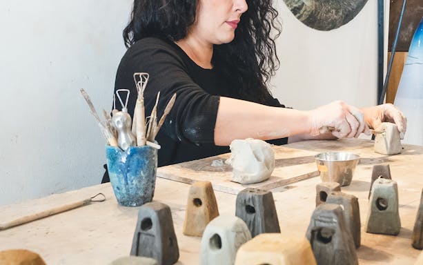 Artisan crafting clay sculptures in Ortigia, Siracusa.
