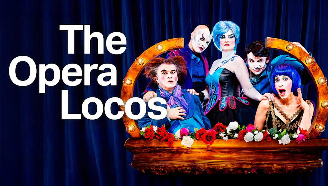 Performers in colorful costumes from The Opera Locos show on stage.