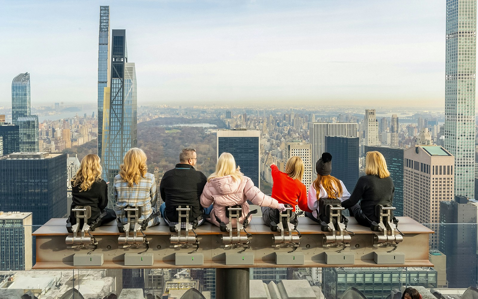 People sitting on The Beam, Top of the Rock, Rockefeller Center, New York