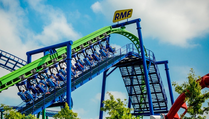 Energylandia RMF Dragon roller coaster ride with vibrant loops and twists in Zator, Poland.