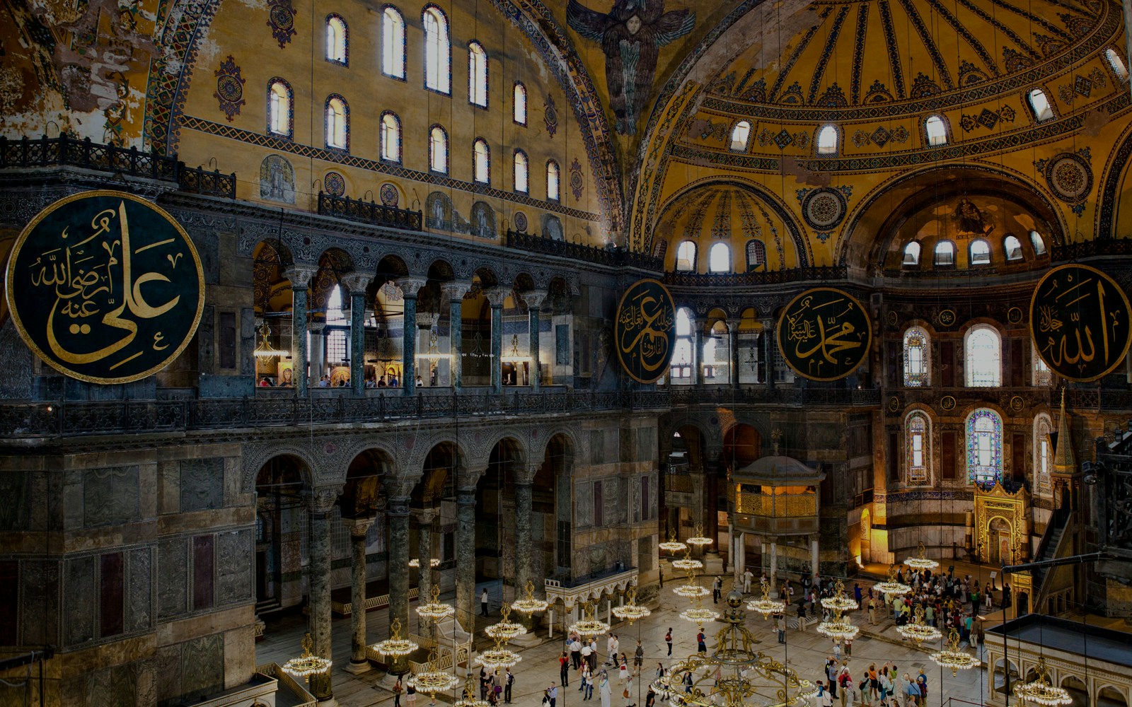 Interior view of Hagia Sophia with ornate domes and Arabic calligraphy, Istanbul.
