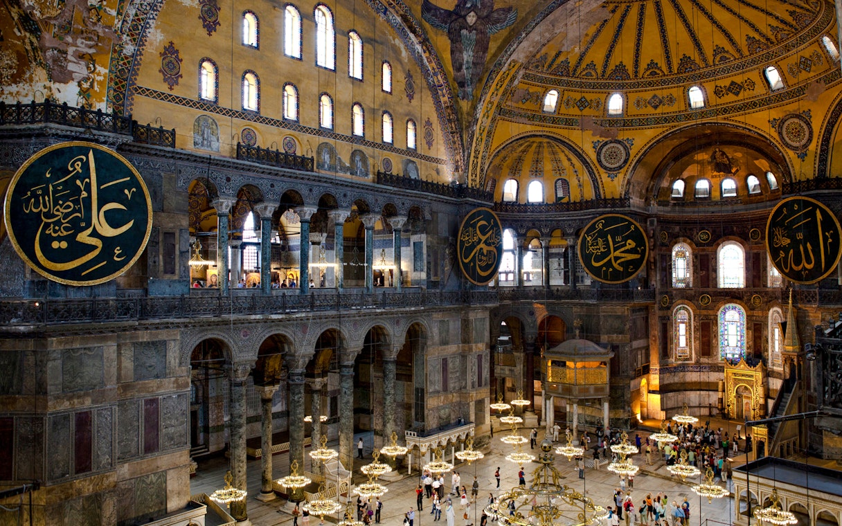 Interior view of Hagia Sophia with ornate domes and Arabic calligraphy, Istanbul.
