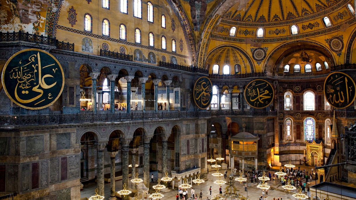 Interior view of Hagia Sophia with ornate domes and Arabic calligraphy, Istanbul.
