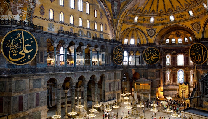 Interior view of Hagia Sophia with ornate domes and Arabic calligraphy, Istanbul.