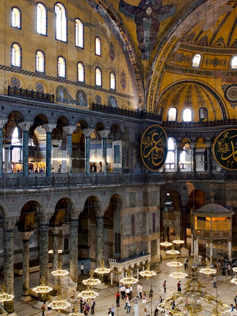 Interior view of Hagia Sophia with ornate domes and Arabic calligraphy, Istanbul.