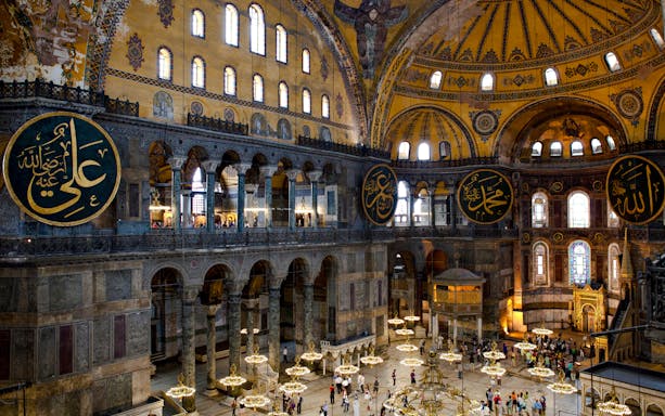 Interior view of Hagia Sophia with ornate domes and Arabic calligraphy, Istanbul.