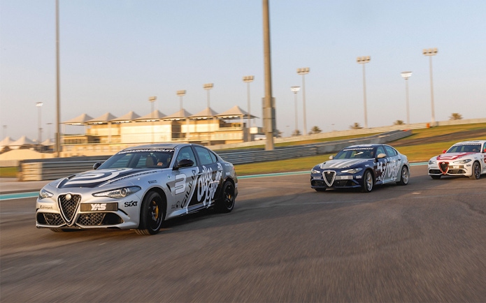 Alfa Romeo Giulia Quadrifoglio cars racing at Yas Marina Circuit.