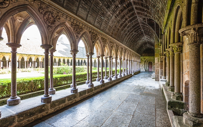 Cloister arches inside Mont Saint Michel abbey, Normandy, France.