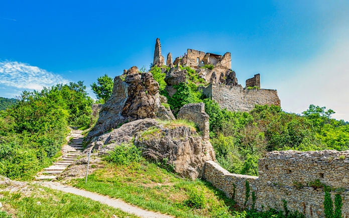 Ruins of Dürnstein Castle in Danube Valley, Austria, surrounded by greenery.
