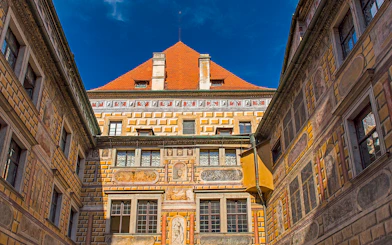 Painted walls of Cesky Krumlov castle courtyard, Czech Republic.