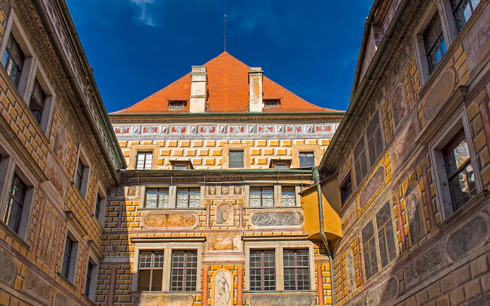 Painted walls of Cesky Krumlov castle courtyard, Czech Republic.