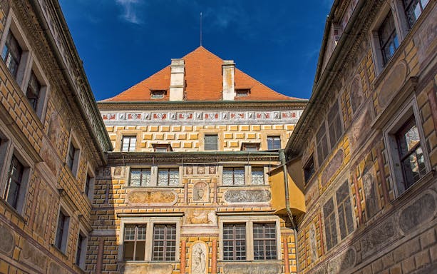 Painted walls of Cesky Krumlov castle courtyard, Czech Republic.