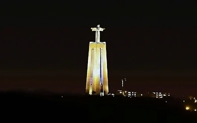 Sanctuary of Christ the King illuminated at night, Lisbon, Portugal.