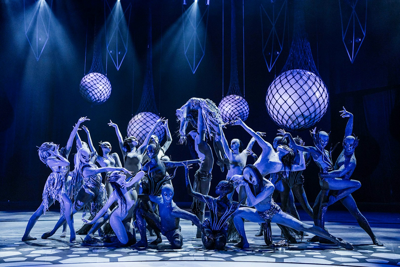 Performers in elaborate costumes on stage at FALLING | IN LOVE Grand Show.