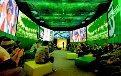 Guests at Heineken Experience in Amsterdam enjoying interactive exhibits and tasting area.
