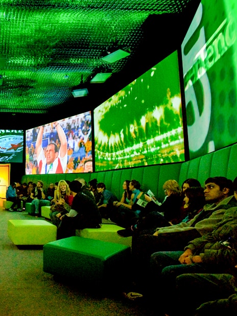 Guests at Heineken Experience in Amsterdam enjoying interactive exhibits and tasting area.