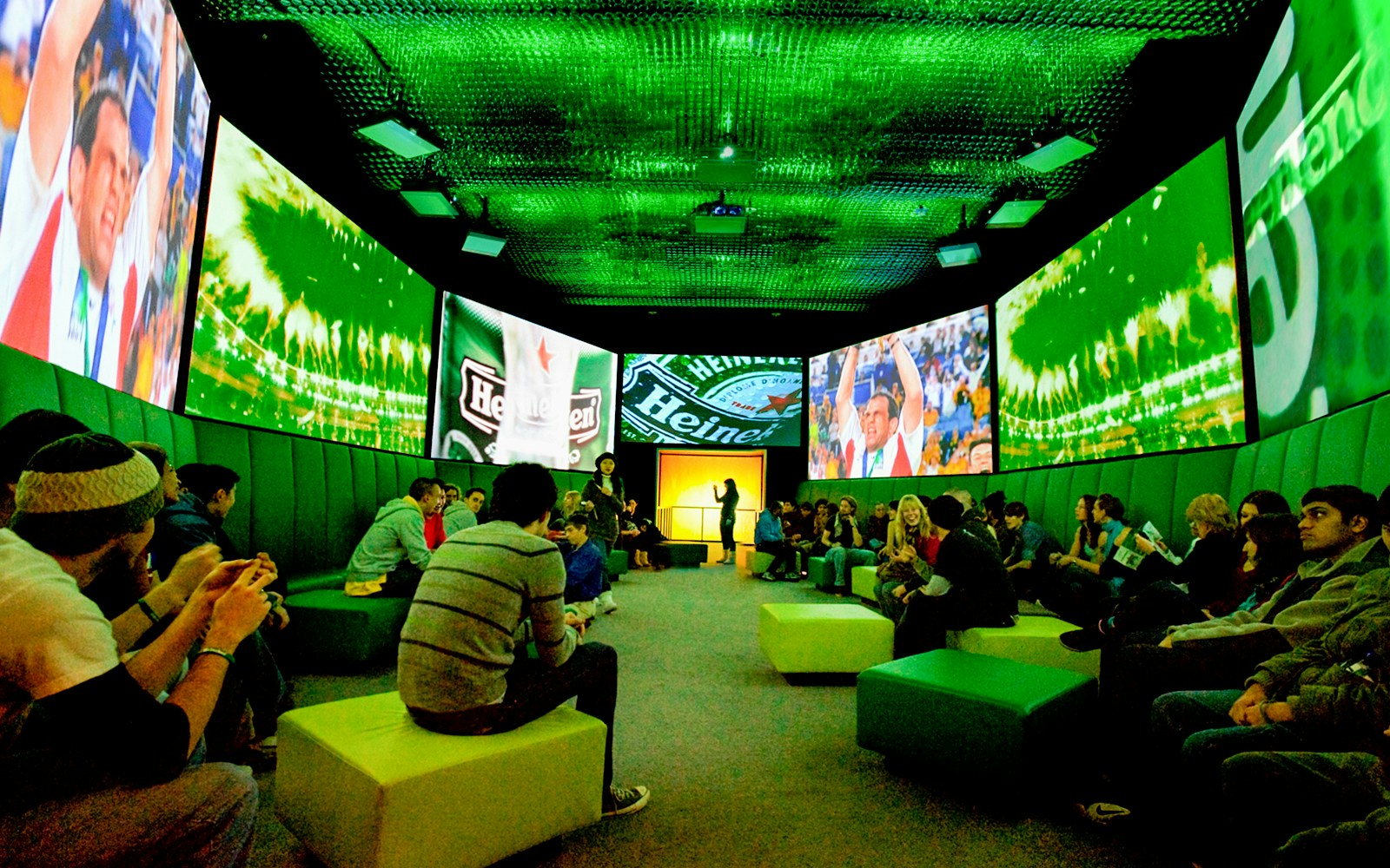 Guests at Heineken Experience Amsterdam exploring interactive exhibits and tasting area.