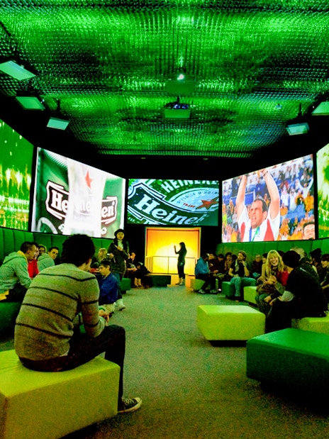 Guests at Heineken Experience in Amsterdam enjoying interactive exhibits and tasting area.